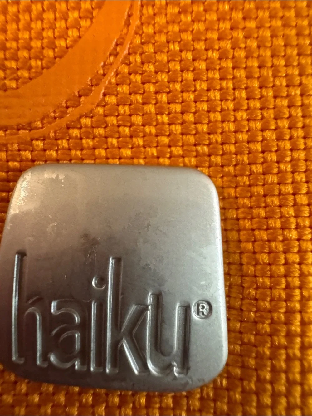 Haiku Orange Floral Embossed Wristlet with Chain Strap
